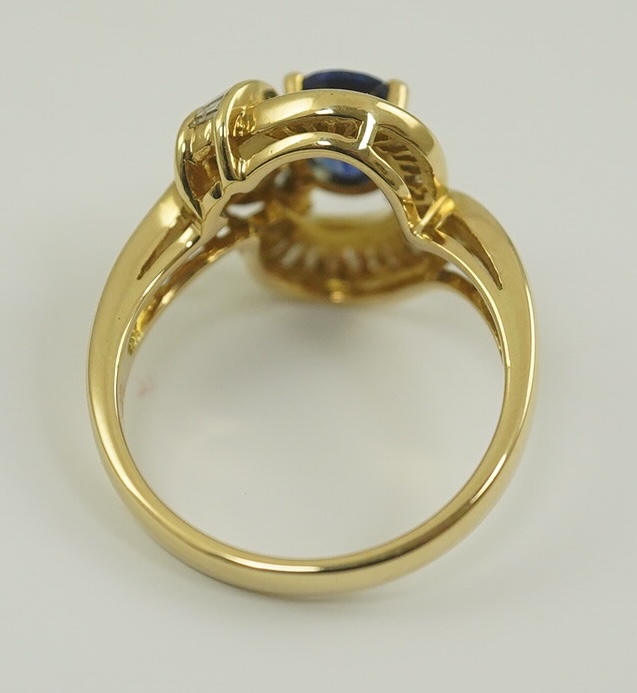 A modern 18k gold, sapphire and diamond cluster set dress ring